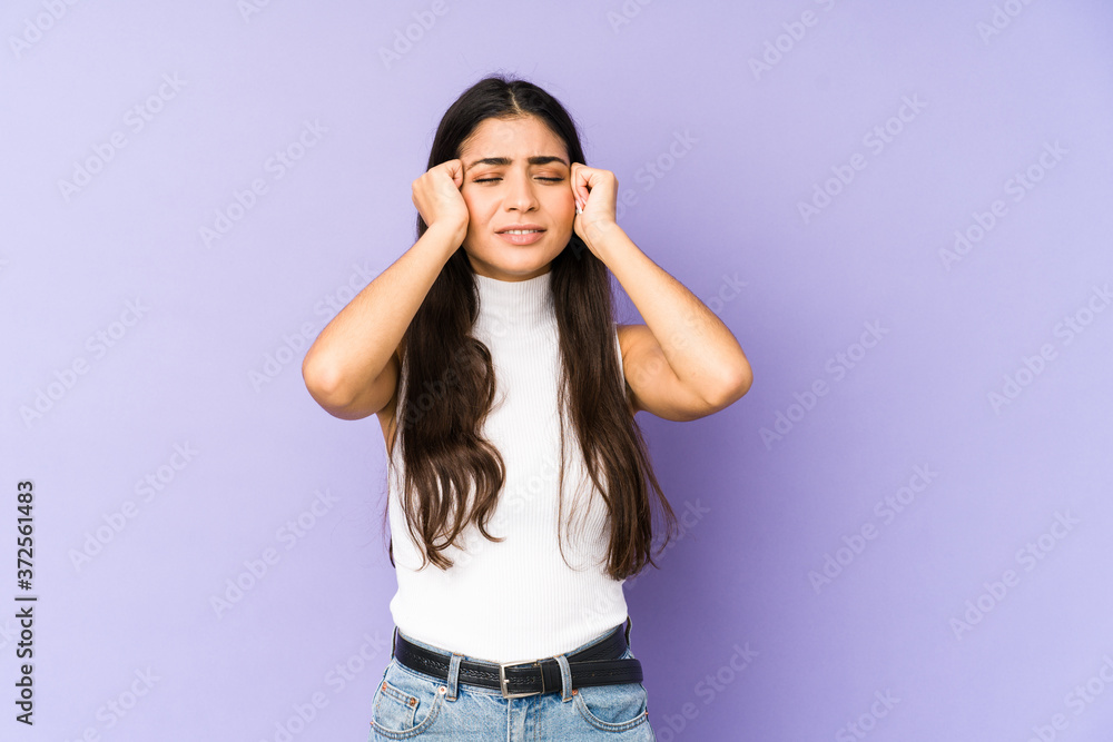 Young indian woman isolated on purple background crying, unhappy with something, agony and confusion concept. Young indian woman isolated on purple background crying, unhappy with something, agony and confusion concept.