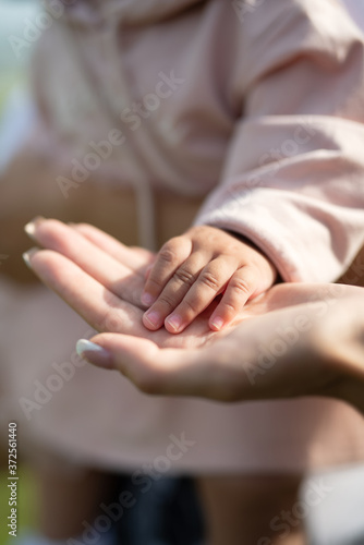 the child put his hand on his mother's hand