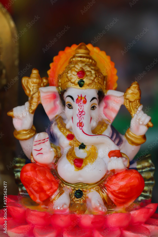 Colorful Painted Handcrafted Statue Of Indian Hindu Lord God Idol Ganesha Ganpati Made Of Earthenware Mud Clay Stone Or Rock For Worship Pooja Puja In Deepawali Deepavali Diwali And Chaturthi Festival