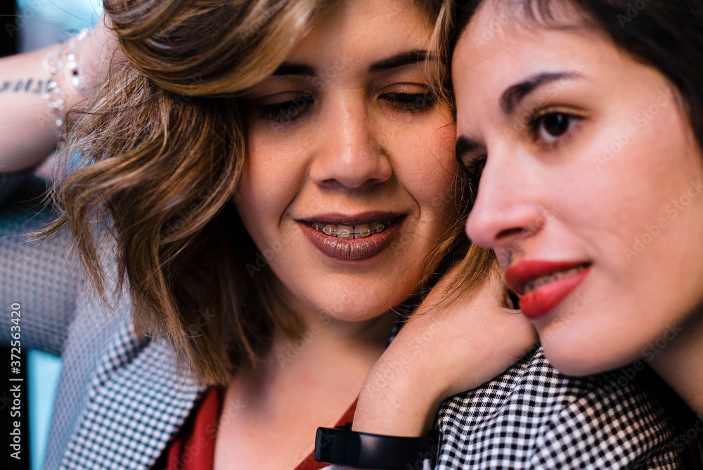 Close-up of thoughtful woman leaning on girlfriend's shoulder