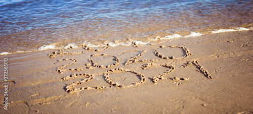 The inscription on the sand 2020 and 2021, which is washed away by a wave of water