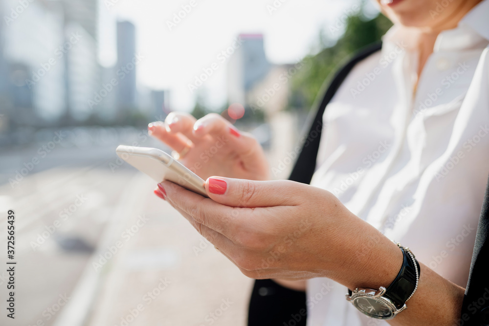 Close-up of businesswoman using smart phone in city Close-up of businesswoman using smart phone in city