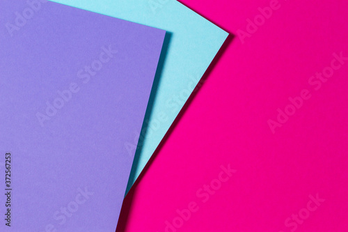 Abstract color papers geometry flat lay composition banner background with purple, blue and magenta color tones