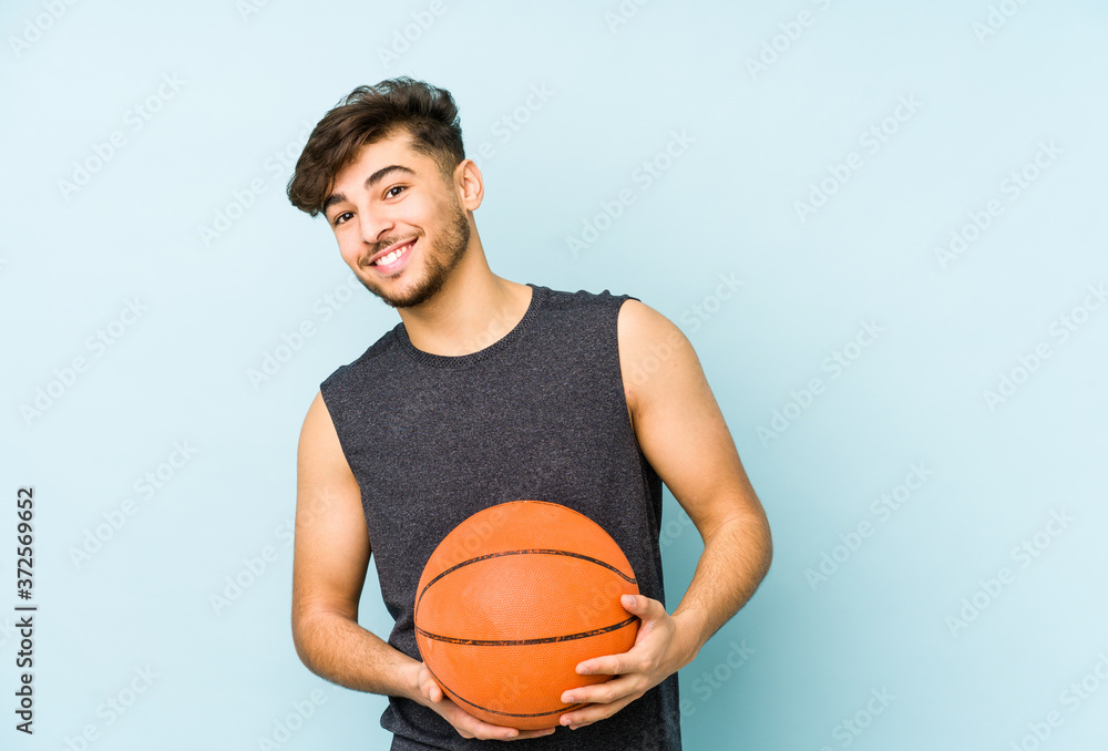 Young arabian man playing basket isolated laughing and having fun. Young arabian man playing basket isolated laughing and having fun.