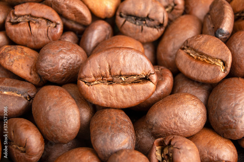 Roasted Coffee beans background close up. International coffee day concept. Macro photography foods. Texture for design.