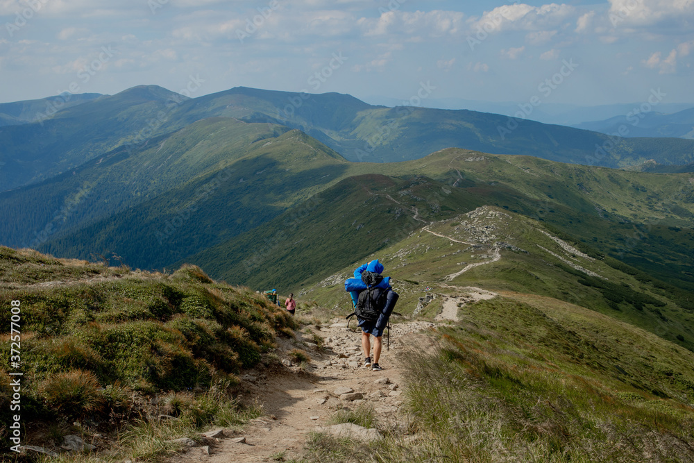 Hiker on the top in Carpathians mountains. Travel sport lifestyle concept