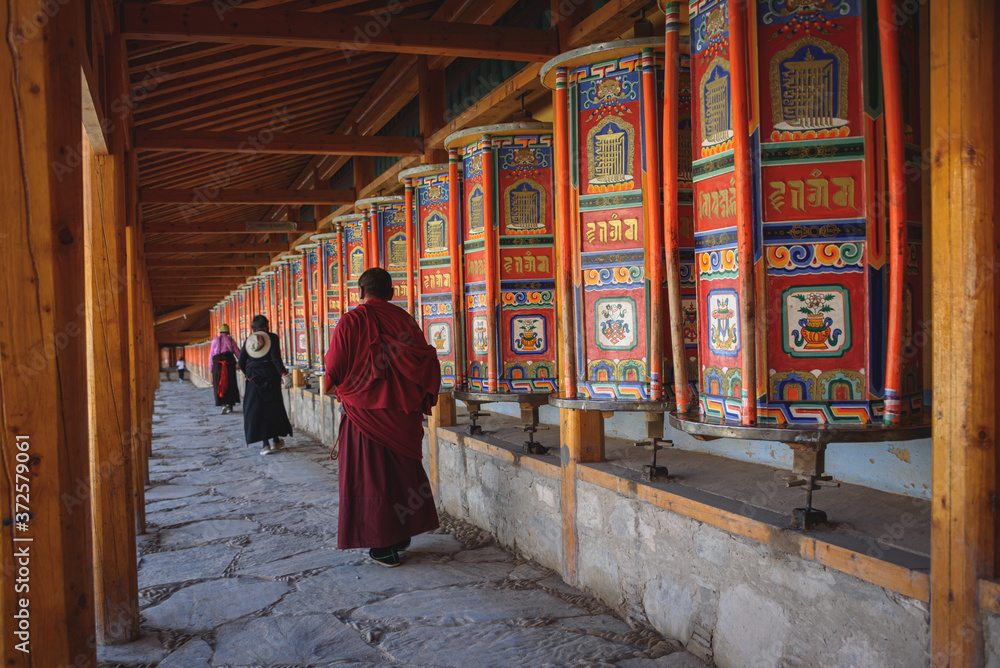 Tibetan prayer wheels at Labrang Monastery in Xiahe County, China. Translation text written in sanskrit means 