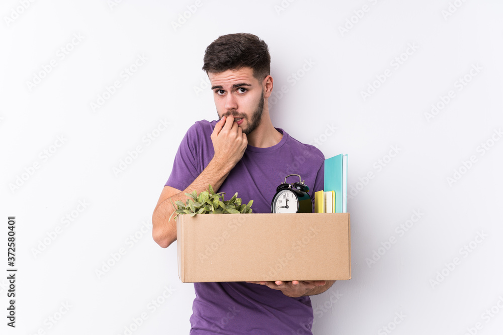 Young caucasian man moving a new home isolated biting fingernails, nervous and very anxious. Young caucasian man moving a new home isolated biting fingernails, nervous and very anxious.