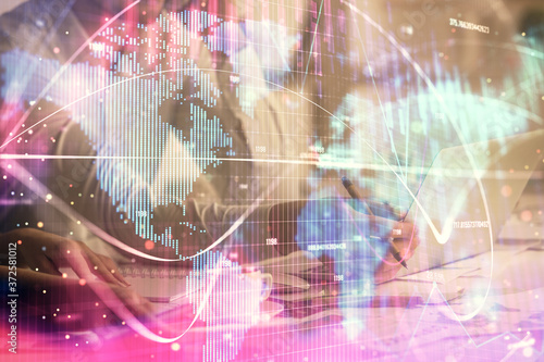 Double exposure of man and woman working together and financial theme hologram. international business concept. Computer background.