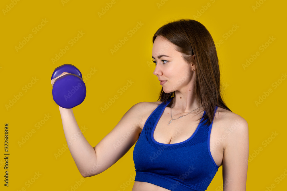 Girl in sports uniform with equipment on a yellow background Girl in sports uniform with equipment on a yellow background