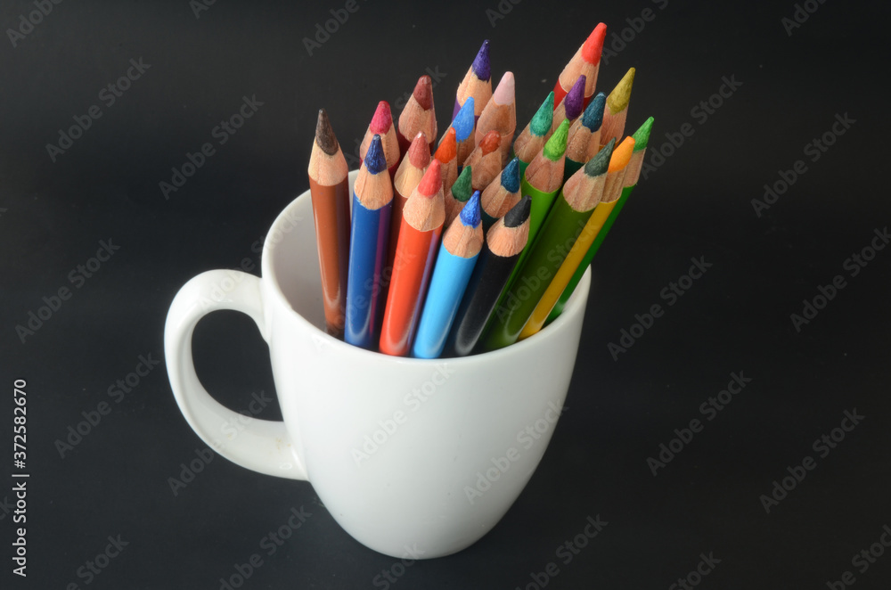 color pencils on a white mug and dark background, colorful, pattern color pencils on a white mug and dark background, colorful, pattern