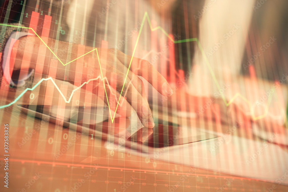 Double exposure of forex graph drawing and man and woman working together holding and using a mobile device. Trade concept. Double exposure of forex graph drawing and man and woman working together holding and using a mobile device. Trade concept.