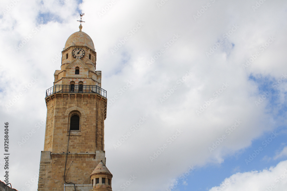 mosque tower with cloudy sky behind