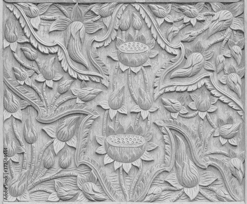 gray gray wooden Pattern of flower carved on wood background © peekeedee
