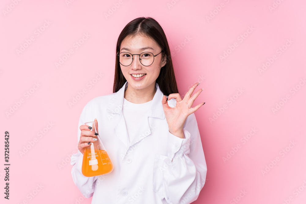 Young chinese scientific woman isolated cheerful and confident showing ok gesture. Young chinese scientific woman isolated cheerful and confident showing ok gesture.