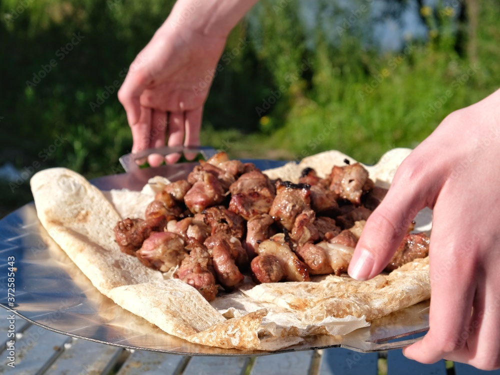 pan with barbecue in hands