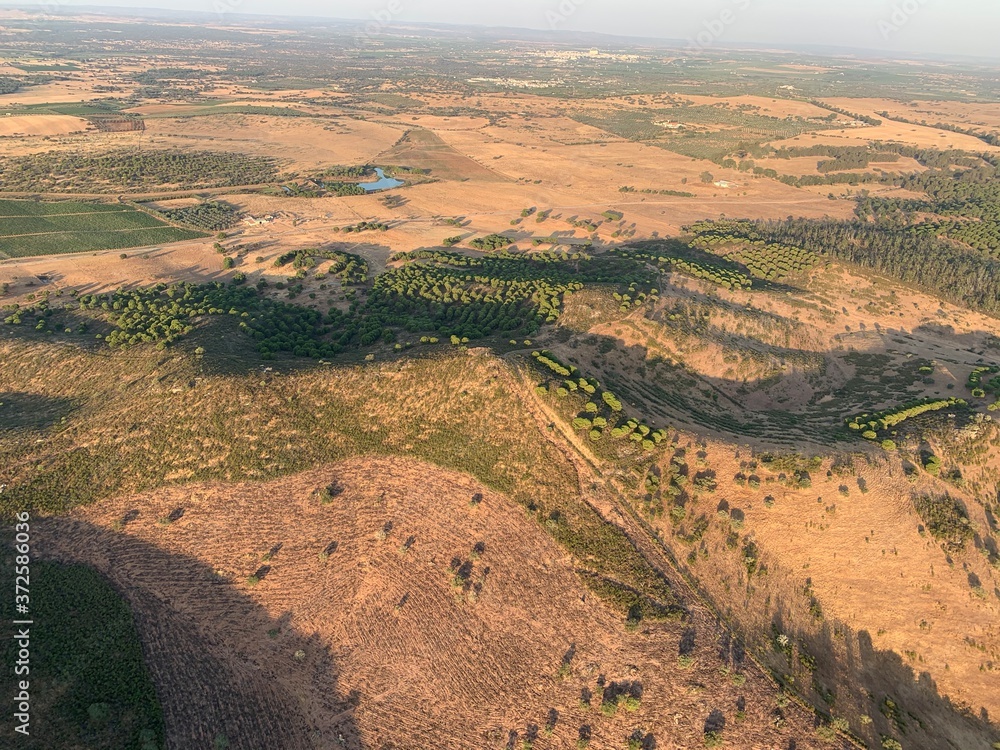 Naklejka premium Hot air balloon flight at sunrise, Aerial View over the great Alqueva lake, in Alentejo, Portugal