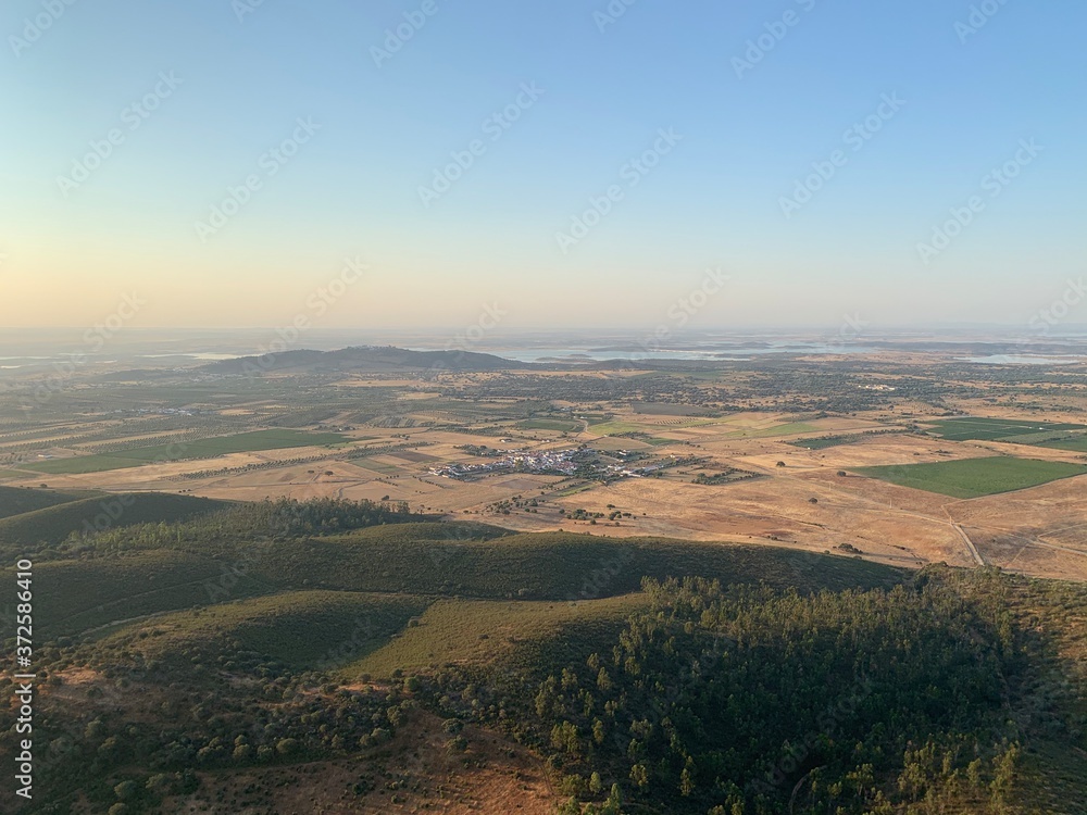 Hot air balloon flight at sunrise, Aerial View over the great Alqueva lake, in Alentejo, Portugal