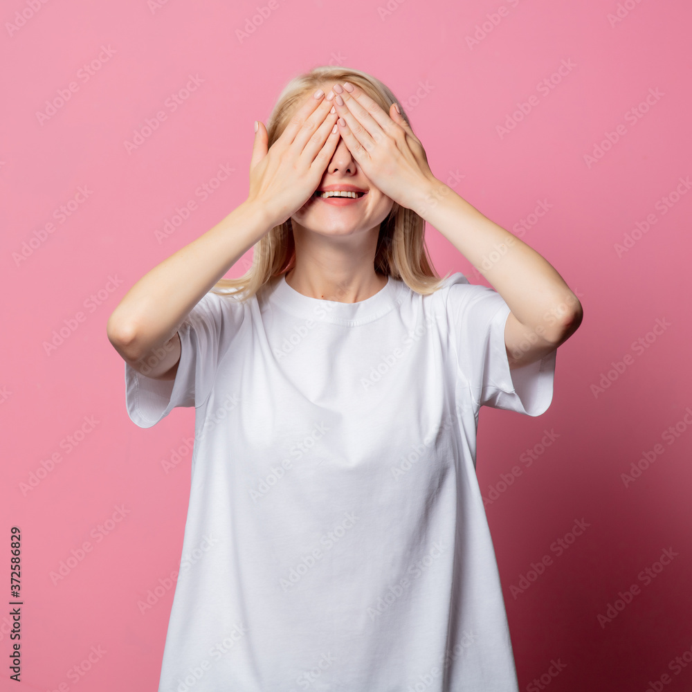 Blonde woman in white moch-up tshirt on pink background Blonde woman in white moch-up tshirt on pink background