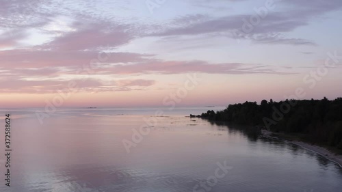 Wallpaper Mural Flying Over Great Lake Rising Over Jutting Piece of Forested Land at Sunrise Torontodigital.ca