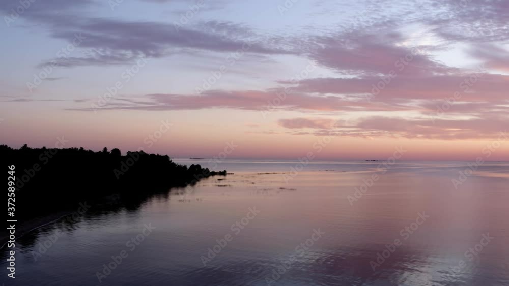 Aerial Drone Of beautiful Sunrise over Lake Rising above Island Land Forest Aerial Drone Of beautiful Sunrise over Lake Rising above Island Land Forest