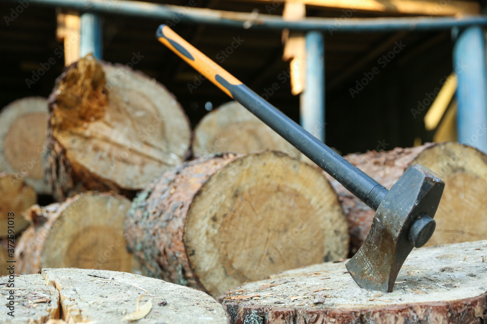 ax on a background of wooden firewood ax on a background of wooden firewood