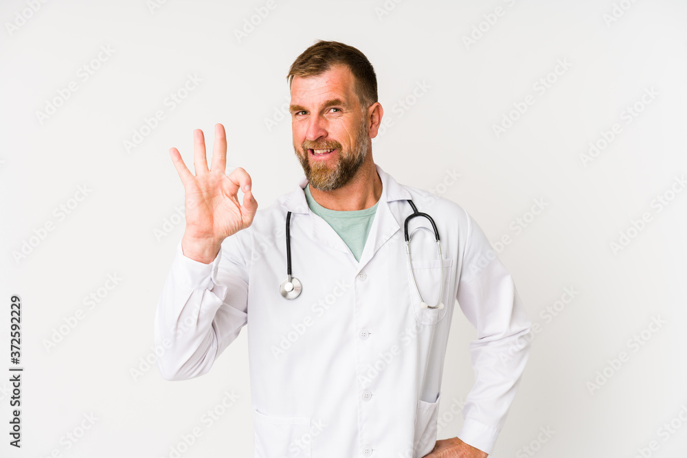 Senior doctor man isolated on white background cheerful and confident showing ok gesture.