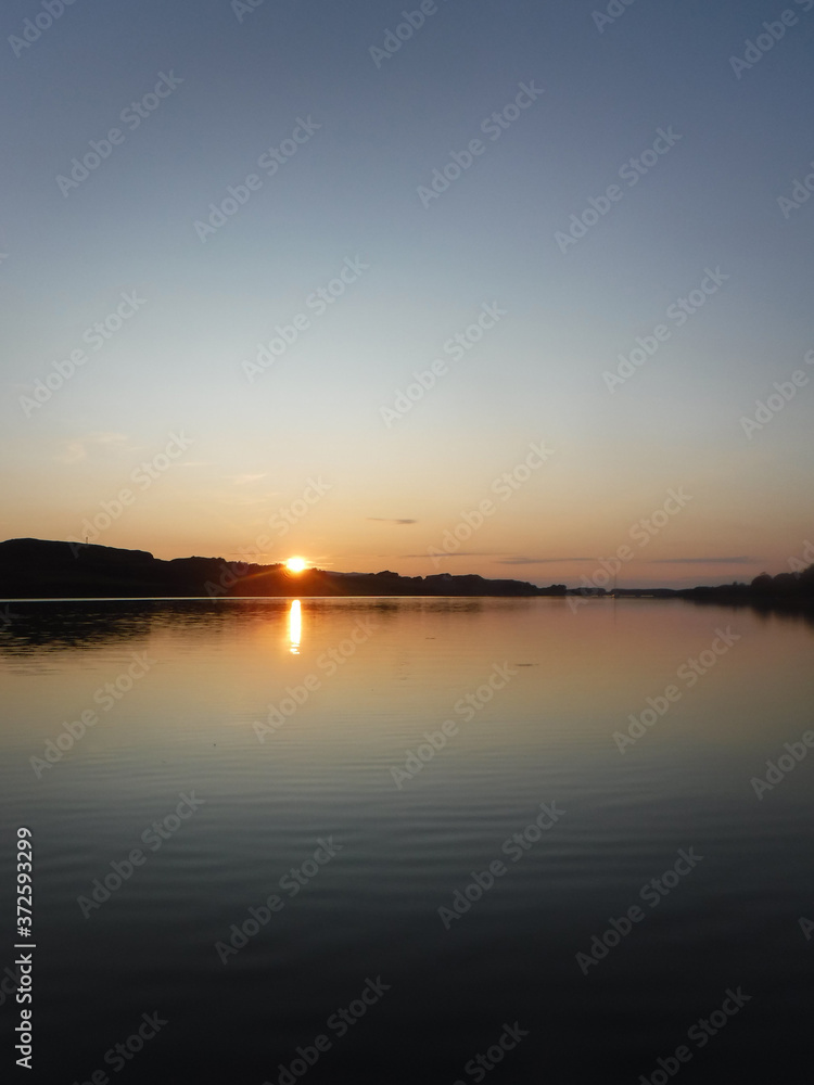 Sunset over a lake from a boat in Ireland