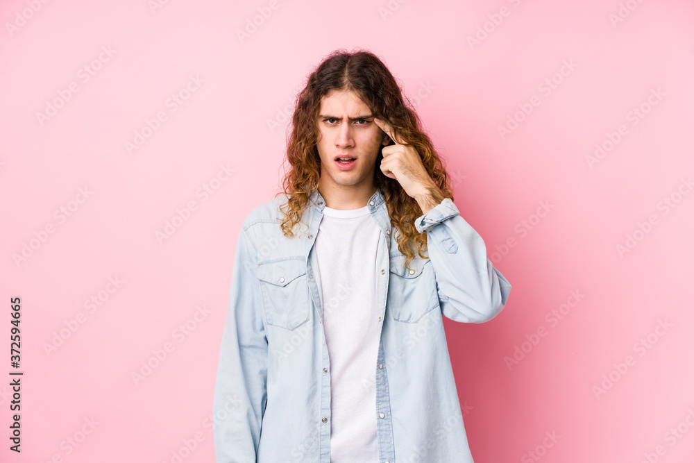 Long hair man posing isolated showing a disappointment gesture with forefinger. Long hair man posing isolated showing a disappointment gesture with forefinger.