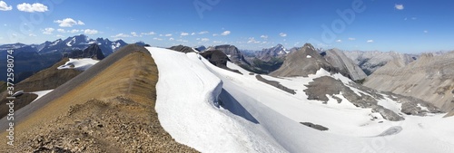 Wide Panoramic Landscape of Rocky Mountain Peaks and Glaciers Hiking Northover Ridge on continental divide between Alberta and British Columbia, Canada photo