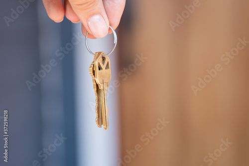 Closeup of woman's fingers holding house keys