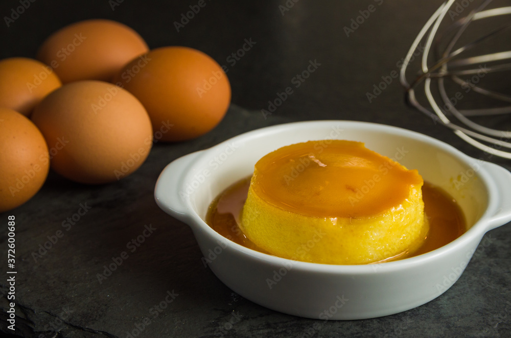 Traditional Brazilian dessert, milk pudding on dark background. Traditional Brazilian dessert, milk pudding on dark background.