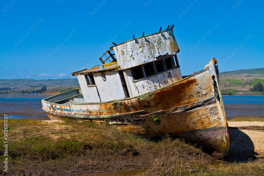 Fishing Boat Stranded on The Beach Of Tomales Bay at Inverness, Pt. Reyes National Sea Shore,California,USA Fishing Boat Stranded on The Beach Of Tomales Bay at Inverness, Pt. Reyes National Sea Shore,California,USA