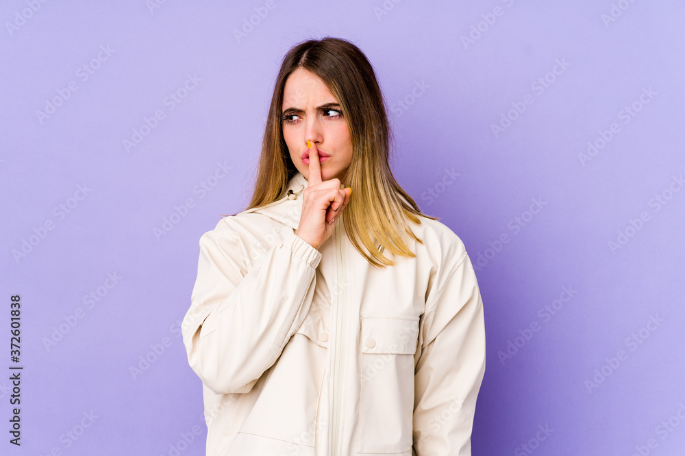 Young caucasian woman isolated on purple background keeping a secret or asking for silence. Young caucasian woman isolated on purple background keeping a secret or asking for silence.