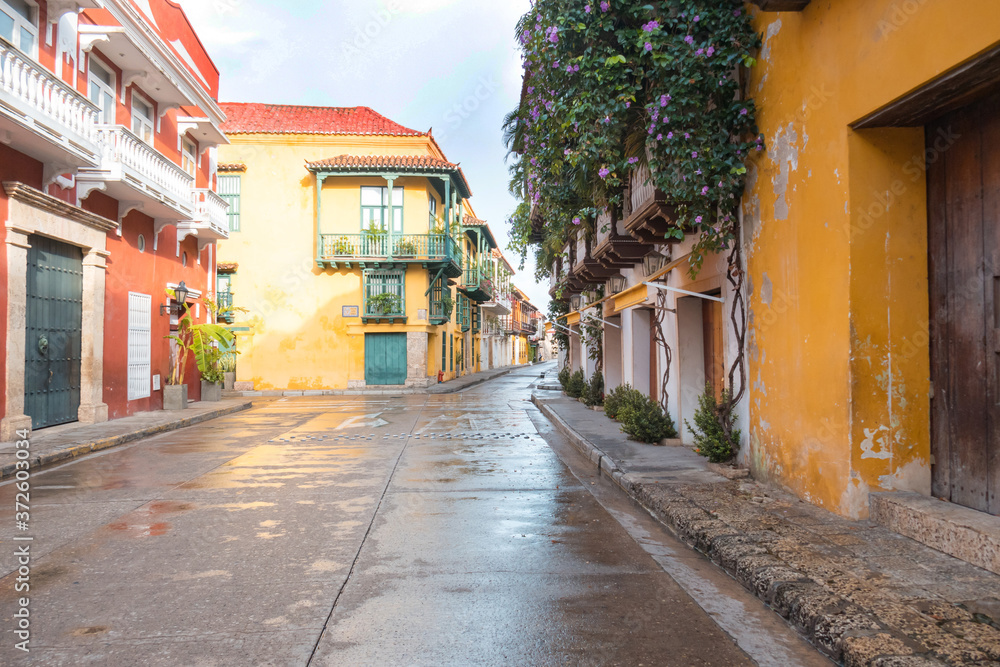 Typical street scene in Cartagena, Colombia of a street with old colonial houses on each side