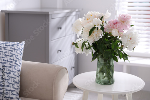 Bouquet of beautiful peony flowers on table indoors