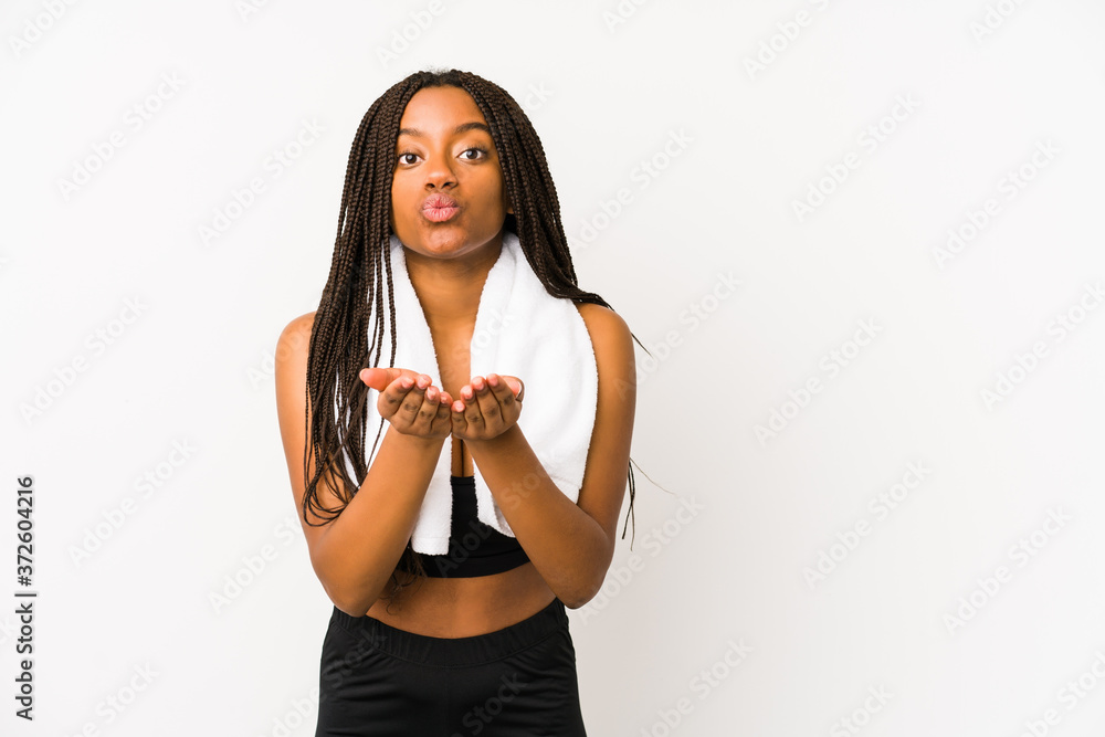 Young african american sport woman isolated folding lips and holding palms to send air kiss. Young african american sport woman isolated folding lips and holding palms to send air kiss.