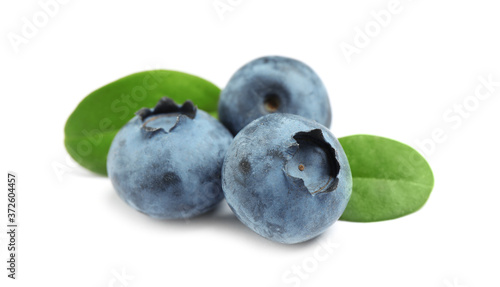 Delicious fresh ripe blueberries with leaves isolated on white