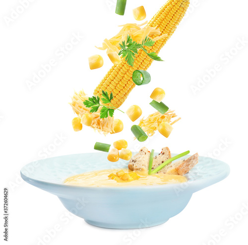Collage with ingredients falling into corn soup on white background