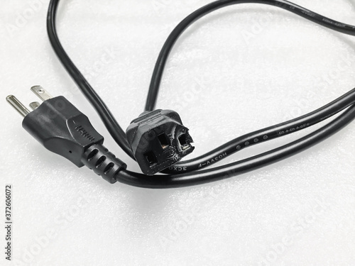 The socket is damaged burns and converter isolated on white background. Improper use of AC Power Plugs and Sockets cause of short circuit and fires at home