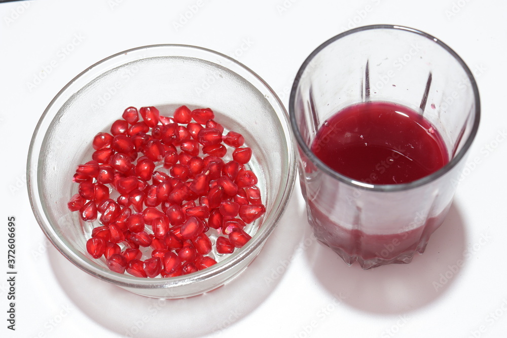 Fresh pomegranate seeds with juice on white background Fresh pomegranate seeds with juice on white background