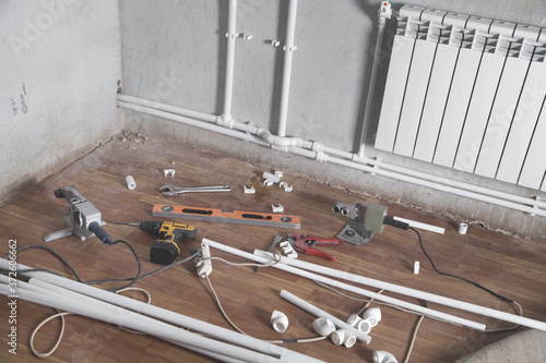 Connecting plastic pipe. Installing water heating radiator photo