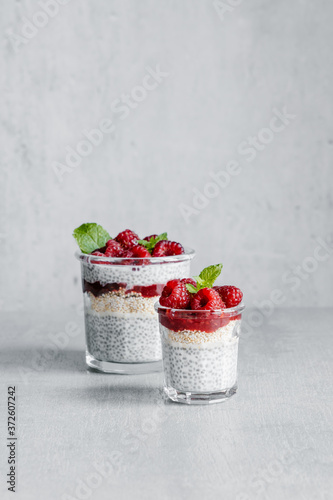 From above of glass filled with delicious pudding made with yogurt raspberries jam and chia seeds photo