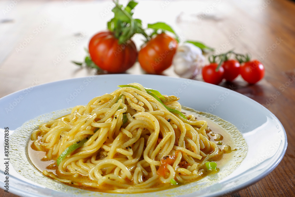 spaghetti dish close up with tomatoes