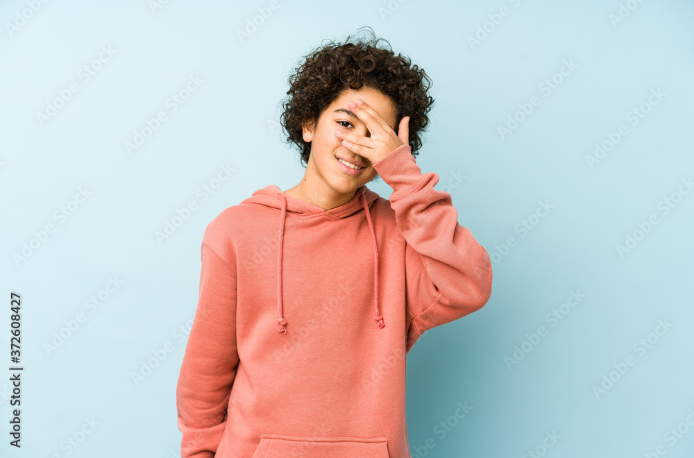 African american little boy isolated blink at the camera through fingers, embarrassed covering face. African american little boy isolated blink at the camera through fingers, embarrassed covering face.