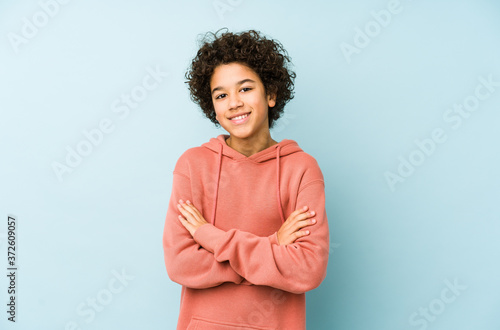 African american little boy isolated who feels confident, crossing arms with determination.