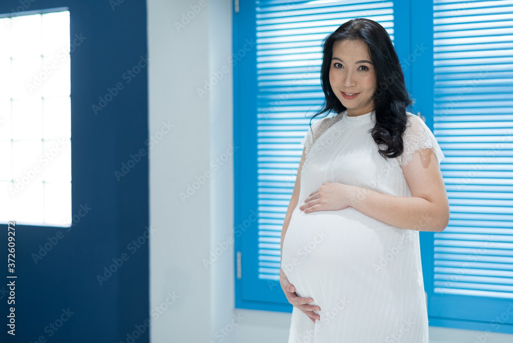 beautiful pregnant women, mother holding baby in pregnant belly
