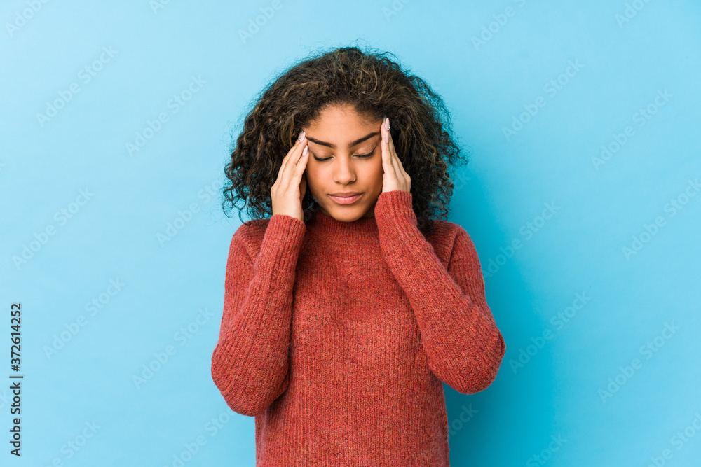 Young african american curly hair woman touching temples and having headache. Young african american curly hair woman touching temples and having headache.
