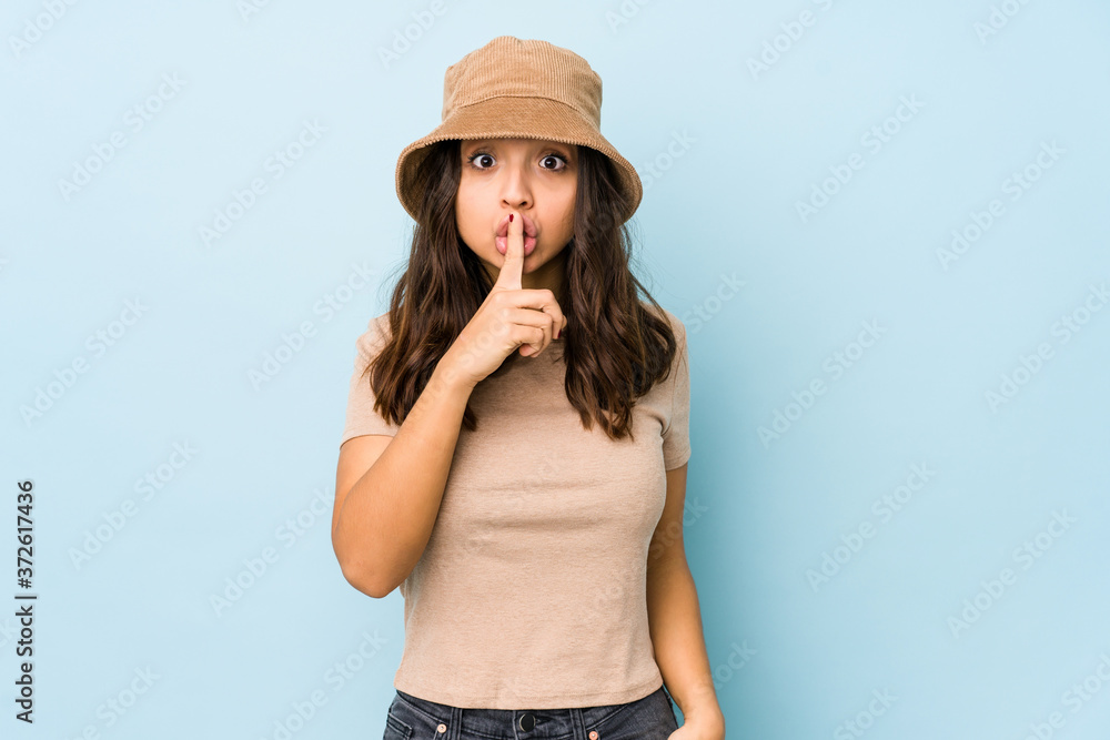 Young mixed race hispanic woman isolated keeping a secret or asking for silence. Young mixed race hispanic woman isolated keeping a secret or asking for silence.