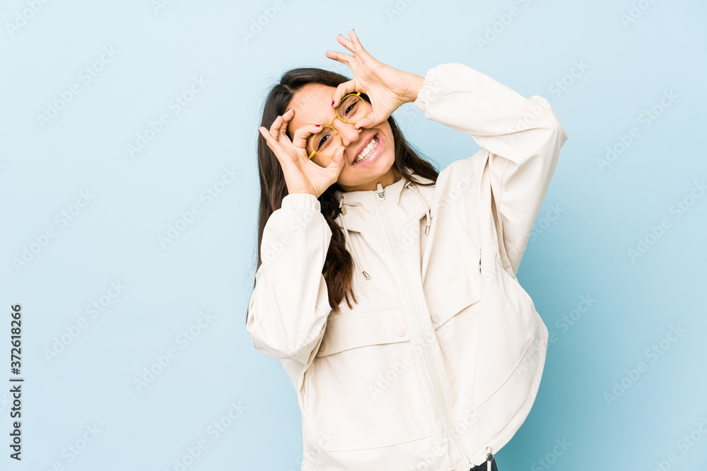 Young mixed race hispanic woman isolated showing okay sign over eyes Young mixed race hispanic woman isolated showing okay sign over eyes